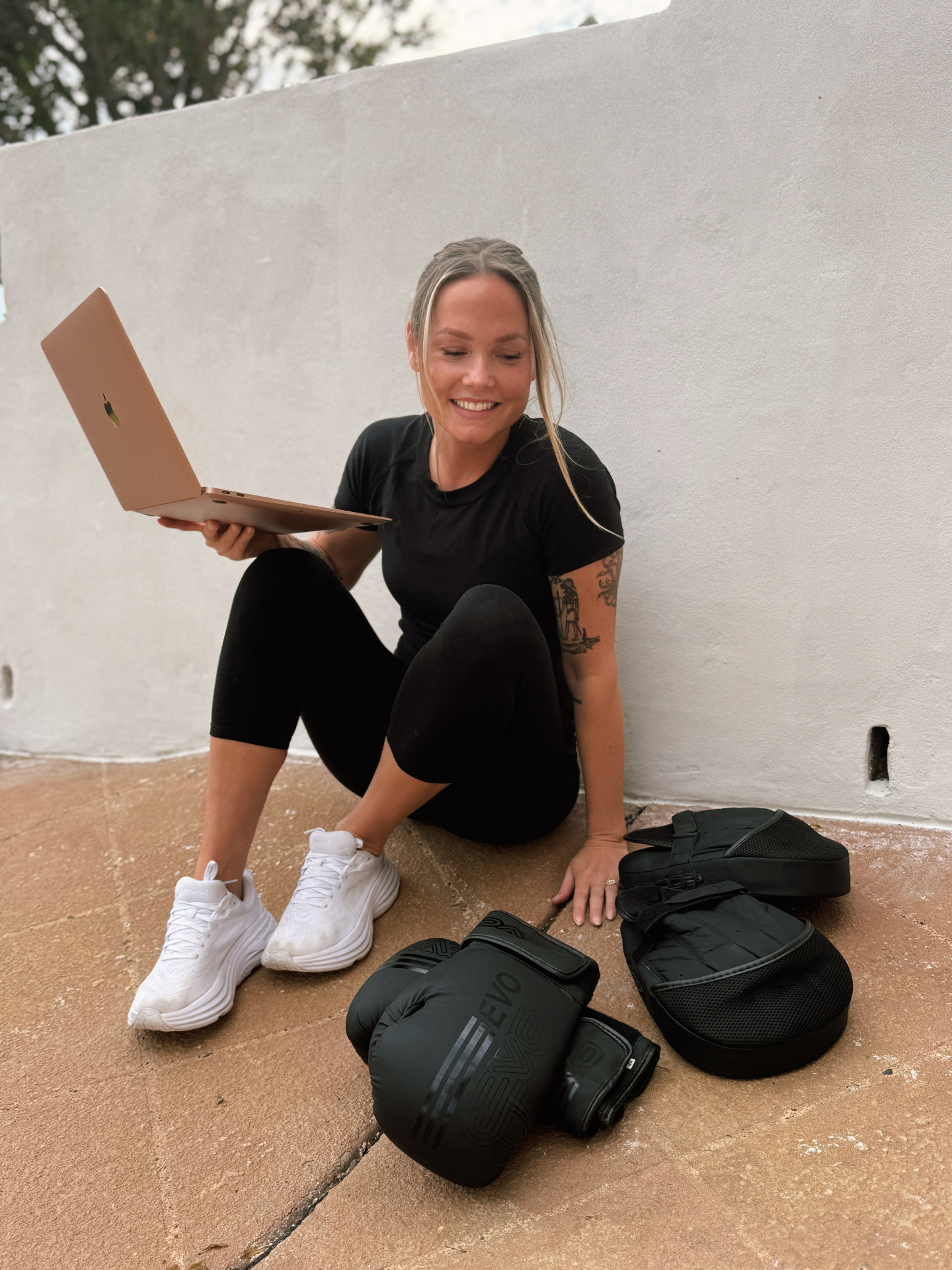 Heidi Sallabank, personal trainer at Path Studio Co, smiling with a laptop